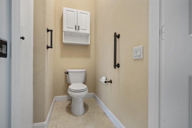 bathroom with tile patterned flooring and toilet