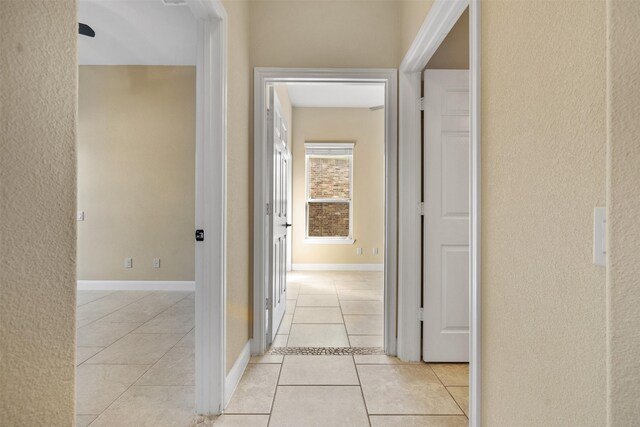 corridor featuring light tile patterned floors