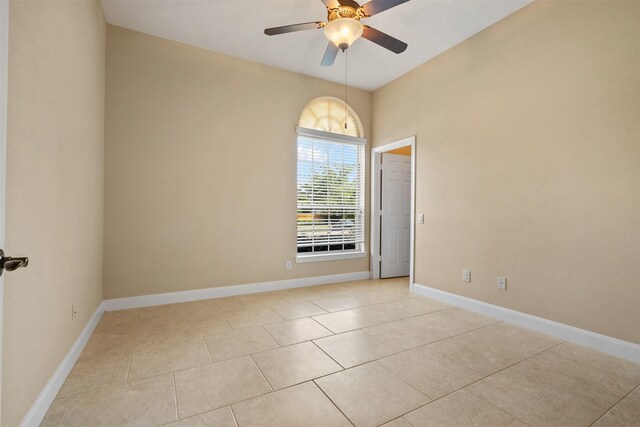 empty room featuring ceiling fan and light tile patterned flooring