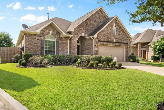 view of front of home featuring a garage and a front yard