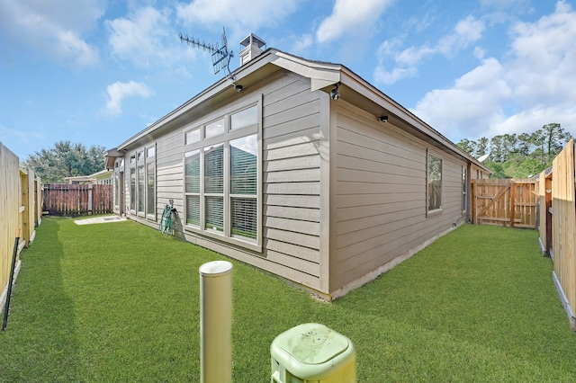 view of home's exterior with a lawn