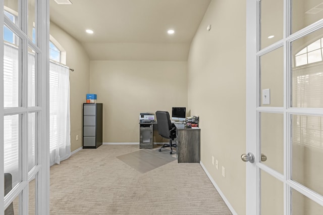 carpeted office with french doors, plenty of natural light, and vaulted ceiling