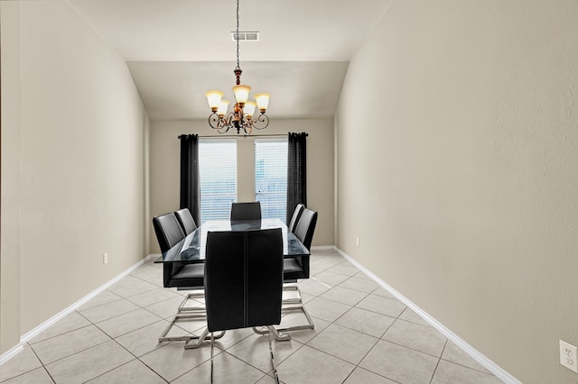 tiled dining area with a chandelier