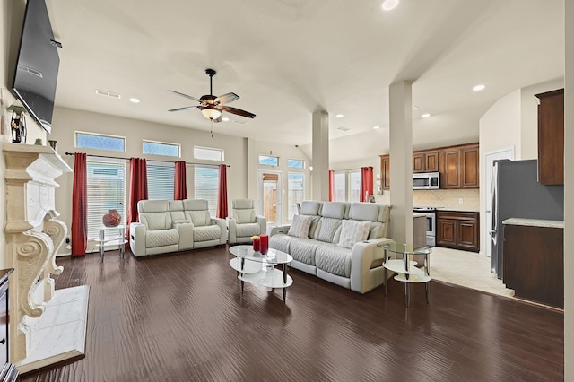 living room with a wealth of natural light, ceiling fan, and light hardwood / wood-style floors