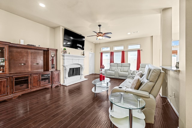 living room featuring ceiling fan and dark hardwood / wood-style floors