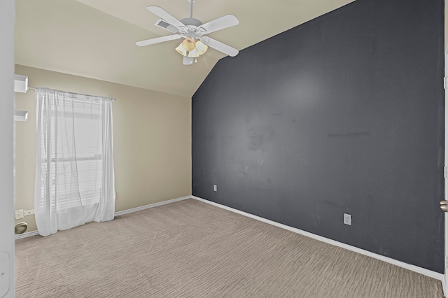 unfurnished room featuring light colored carpet, lofted ceiling, and ceiling fan