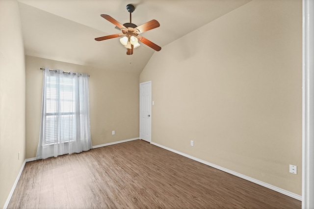 spare room with lofted ceiling, ceiling fan, and wood-type flooring