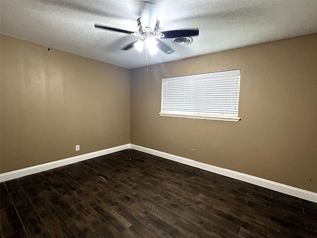 unfurnished room with ceiling fan, a textured ceiling, and dark hardwood / wood-style floors