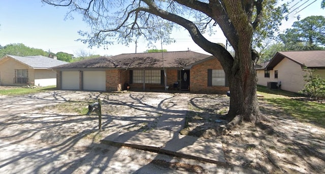 single story home featuring a garage and central AC