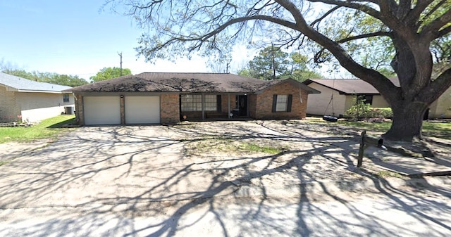 ranch-style house featuring a garage