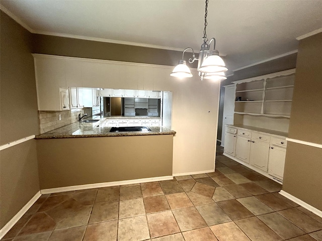 kitchen with white cabinets, decorative backsplash, kitchen peninsula, sink, and decorative light fixtures