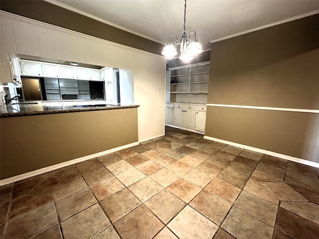 unfurnished dining area with a notable chandelier, sink, and crown molding