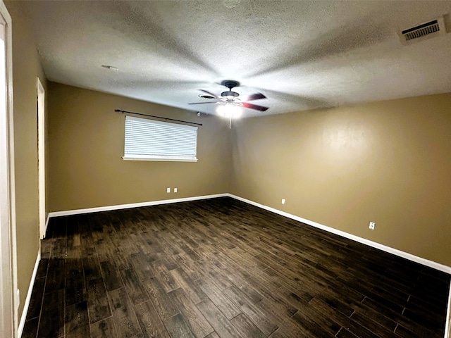 unfurnished room featuring dark hardwood / wood-style flooring and a textured ceiling