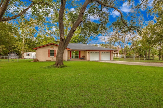 ranch-style house featuring a front yard and a garage