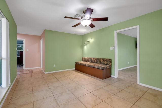 interior space with ceiling fan and light tile patterned floors