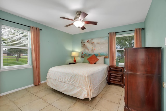 tiled bedroom with multiple windows and ceiling fan