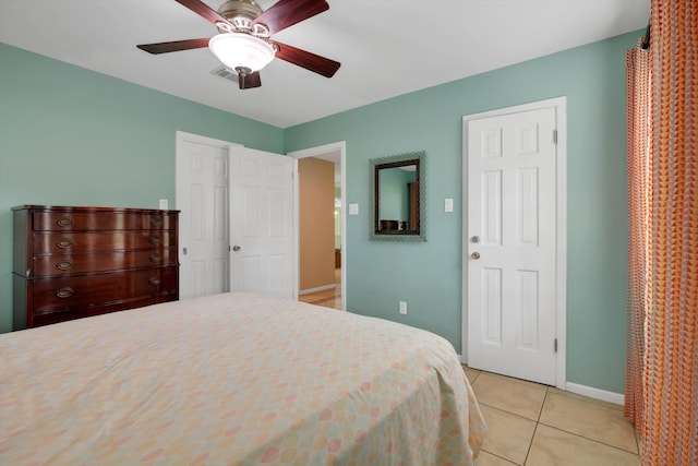 bedroom with ceiling fan and light tile patterned floors