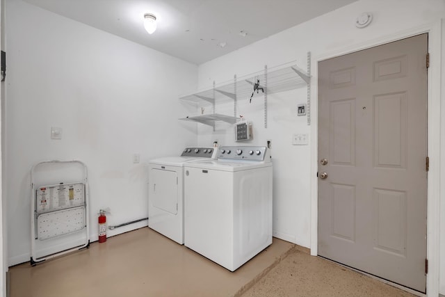 clothes washing area featuring separate washer and dryer