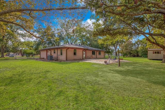 exterior space featuring a yard, a patio, and cooling unit