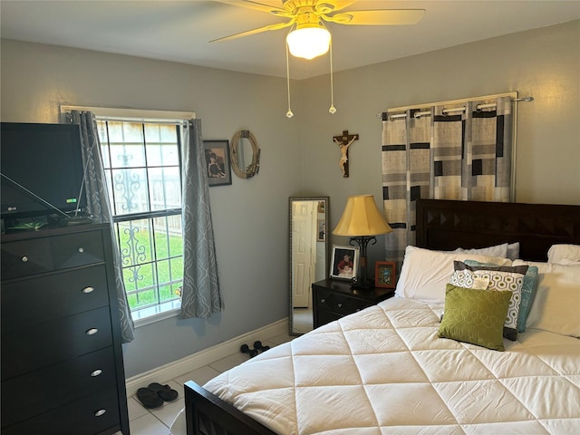 tiled bedroom with ceiling fan