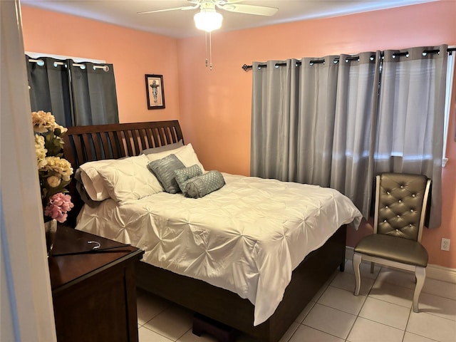 bedroom with ceiling fan and light tile patterned flooring