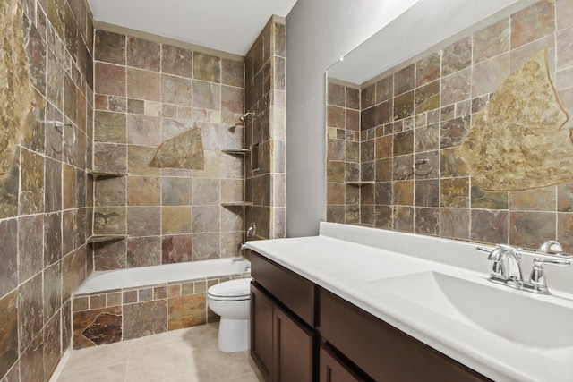 full bathroom with tile patterned flooring, tiled shower / bath, toilet, and vanity