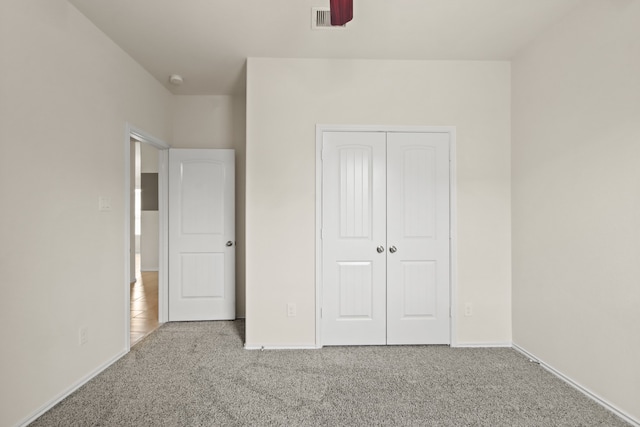 unfurnished bedroom with carpet and a closet