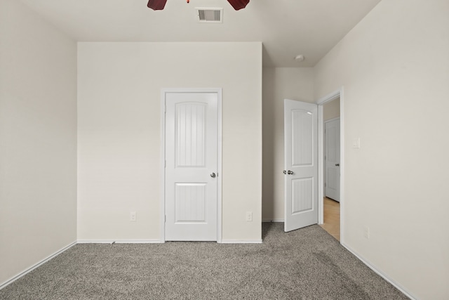 unfurnished bedroom with carpet floors and ceiling fan