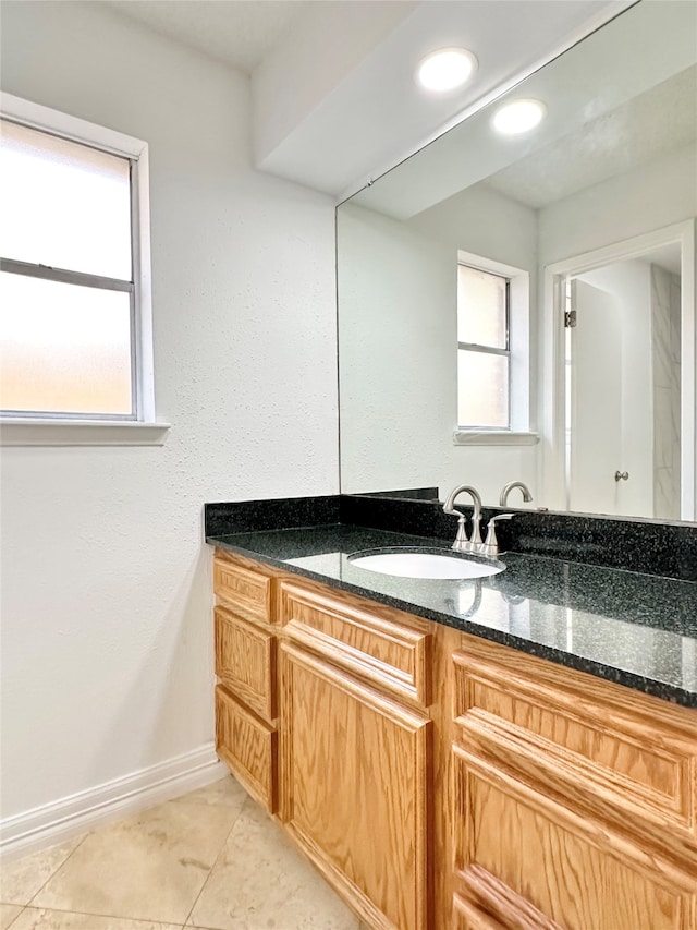 bathroom with tile patterned floors and vanity