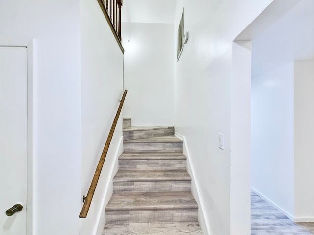 staircase featuring hardwood / wood-style floors