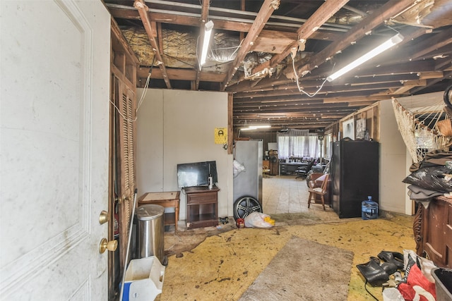 basement with black refrigerator