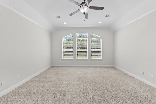 carpeted spare room featuring crown molding, ceiling fan, and lofted ceiling