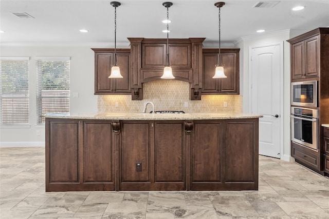 kitchen featuring light stone counters, dark brown cabinetry, and stainless steel appliances