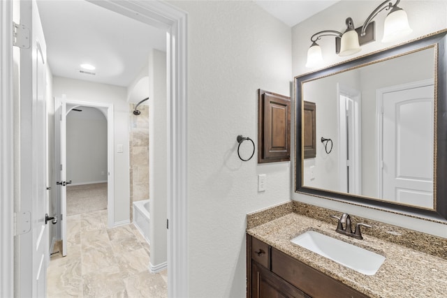 bathroom with vanity and  shower combination