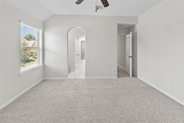 spare room with light carpet, ceiling fan, and lofted ceiling