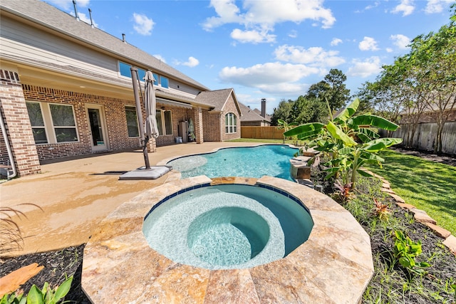 view of pool featuring an in ground hot tub and a patio area