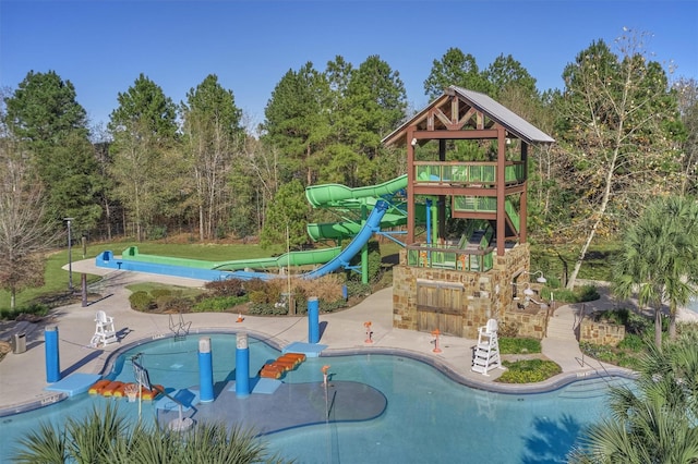 view of swimming pool with a patio and a water slide