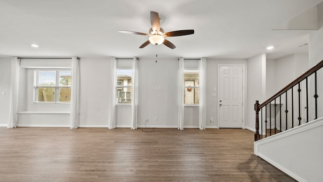 unfurnished living room featuring hardwood / wood-style flooring and ceiling fan