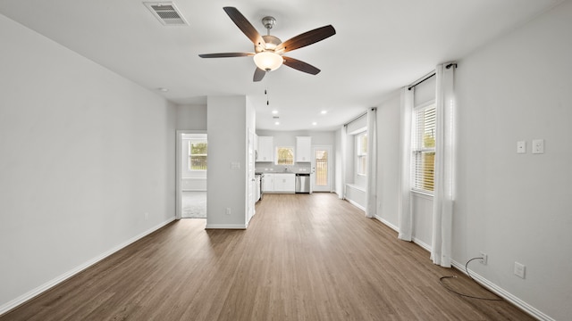 unfurnished living room featuring wood-type flooring and ceiling fan