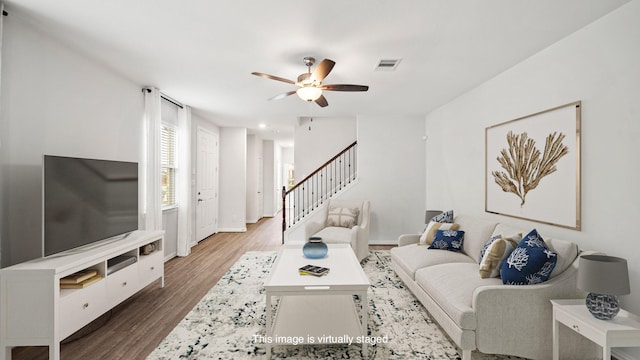 living room featuring ceiling fan and hardwood / wood-style floors