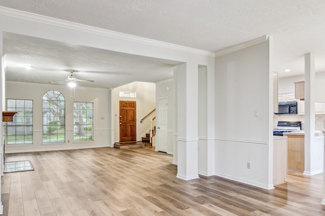 unfurnished living room featuring ornamental molding, ceiling fan, and light hardwood / wood-style floors