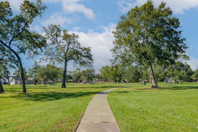 view of community featuring a playground and a yard