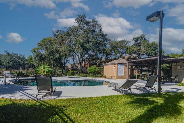 view of swimming pool with a lawn and a patio