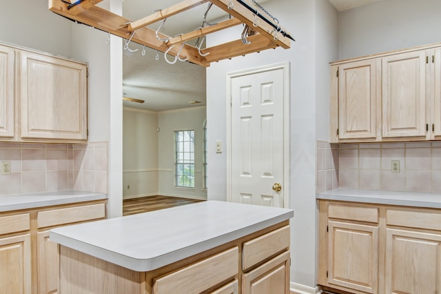 kitchen with light brown cabinets, wood-type flooring, and backsplash