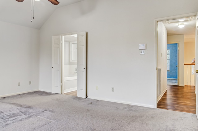 carpeted spare room with vaulted ceiling and ceiling fan