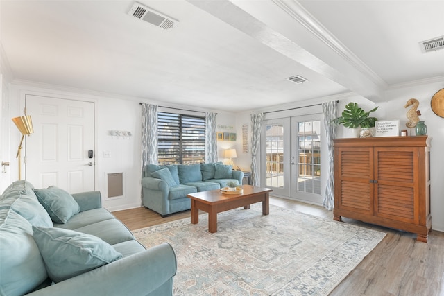 living room with french doors, light hardwood / wood-style floors, and crown molding