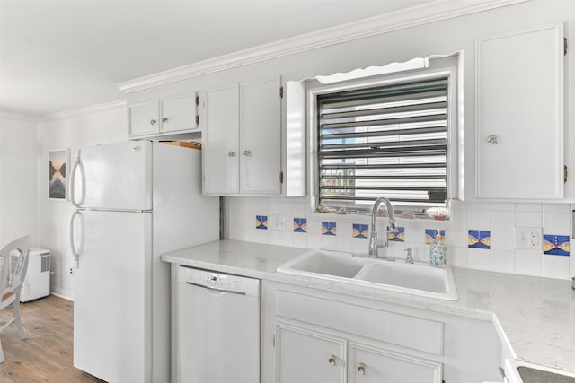 kitchen with white cabinets, sink, crown molding, light wood-type flooring, and white appliances