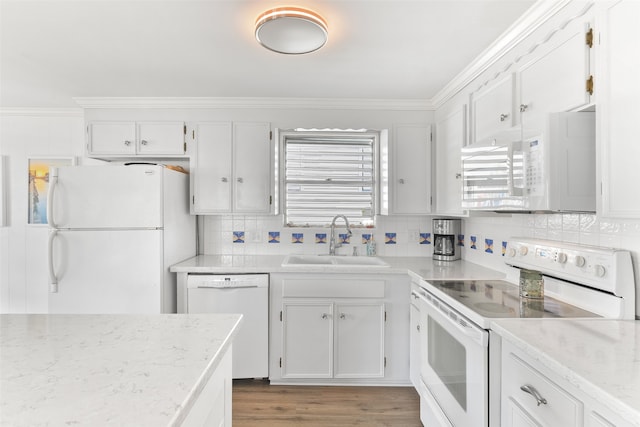 kitchen with crown molding, sink, white cabinets, dark wood-type flooring, and white appliances