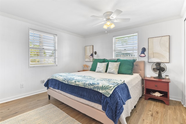 bedroom featuring hardwood / wood-style flooring, ceiling fan, and crown molding