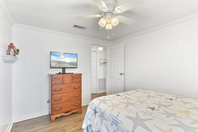 bedroom with ornamental molding, ceiling fan, and light hardwood / wood-style flooring